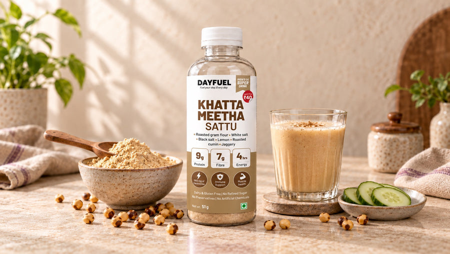 Dayfuel Khatta Meetha Sattu bottle with a glass of sattu drink, roasted gram flour and sliced cucumber