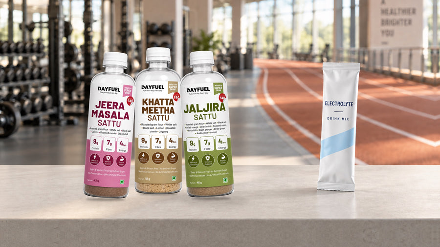 Dayfuel Jeera Masala, Khatta Meetha and Jaljira sattu bottles beside an electrolyte drink mix sachet in a gym