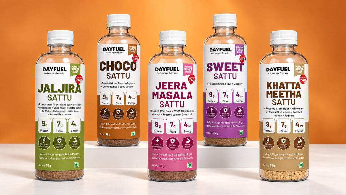 The five Dayfuel sattu drinks, Jaljira, Choco, Jeera Masala, Sweet and Khatta Meetha, on a white plinth against an orange backdrop